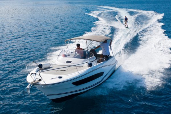 Speedboat with wakeboard rider on open sea. Leasure activities and adrenalin sport concept